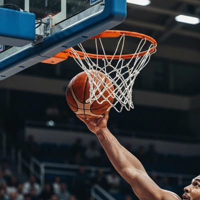Professional basketball game action with players in motion on a polished court